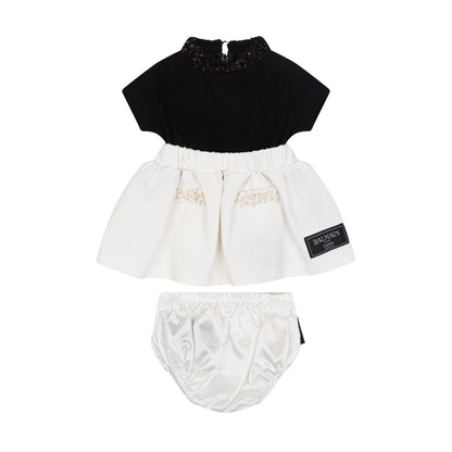 Black top and white skirt with bloomers set on a white background