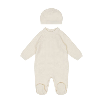 Cream-colored baby onesie with matching hat on a white background
