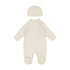 Cream-colored baby onesie with matching hat on a white background