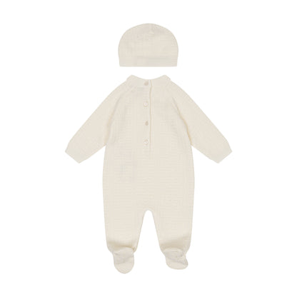White baby onesie with hat on a white background