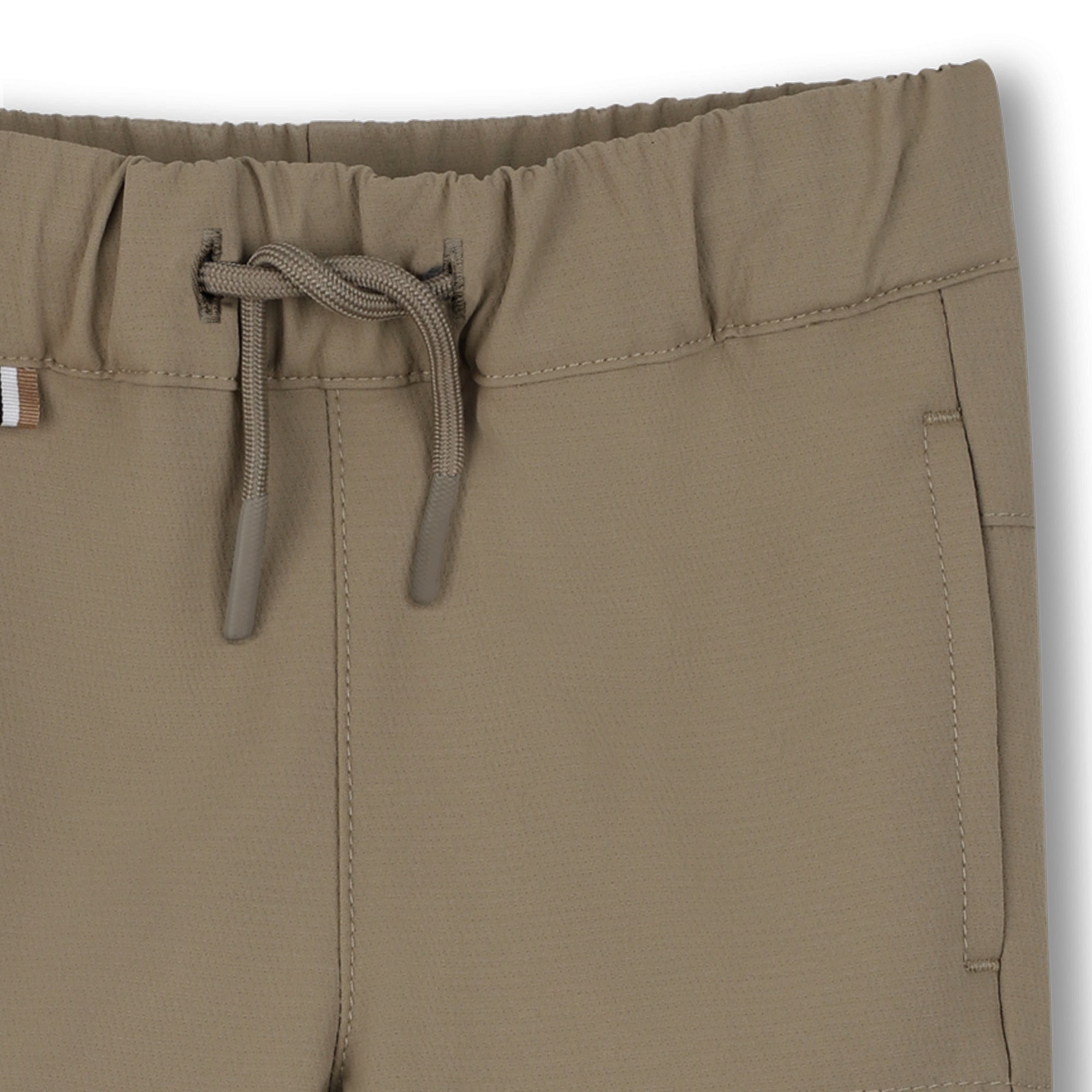 Close-up of brown pants with a drawstring on a white background